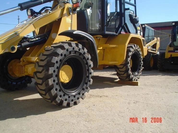 A yellow and black tractor with large tires.