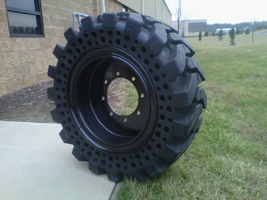 A large tire sitting on top of a cement slab.