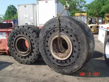 Two large tires are chained to a chain.