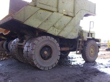 A large dump truck with many tires on it.