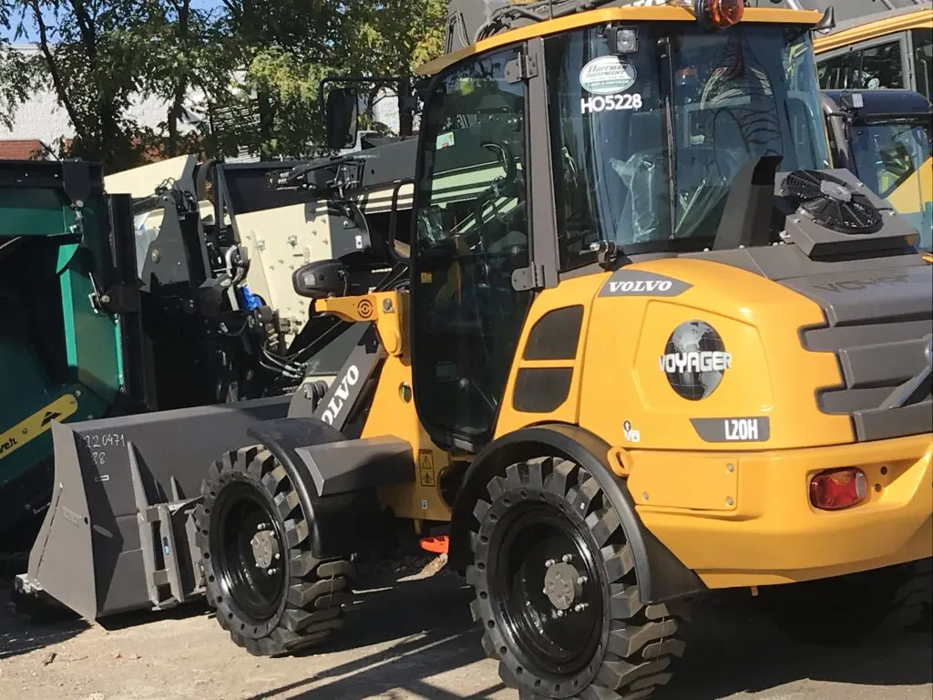 A yellow and black tractor parked in the street