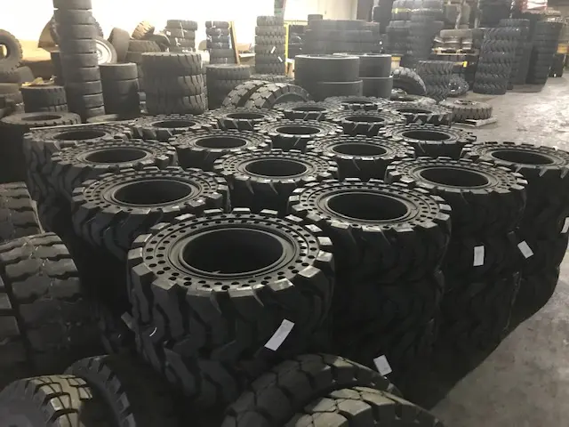 A large group of tires in a warehouse.
