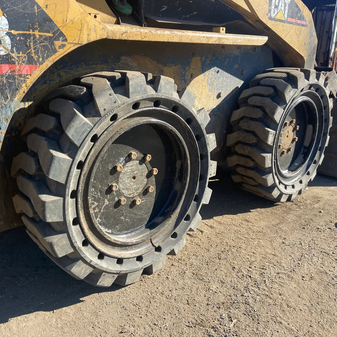 A close up of the tires on a skid steer.
