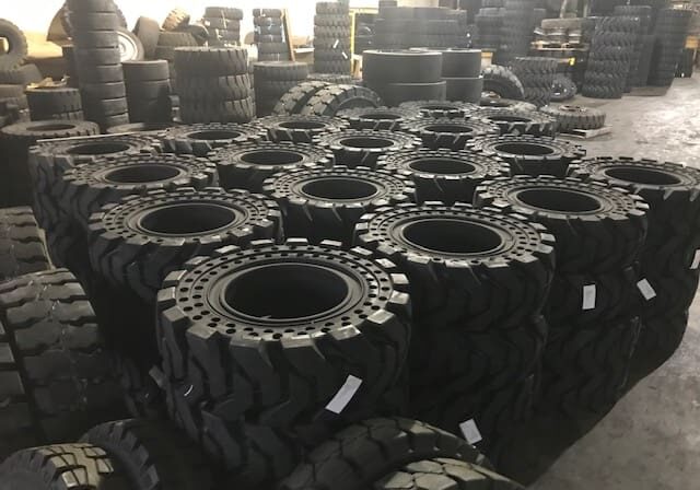 A large group of tires in a warehouse.
